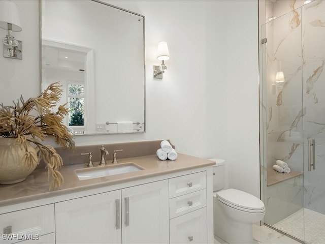 bathroom featuring toilet, vanity, and walk in shower