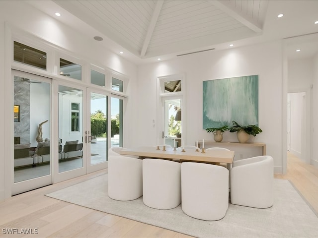 living room with beam ceiling, wooden ceiling, high vaulted ceiling, and light hardwood / wood-style floors