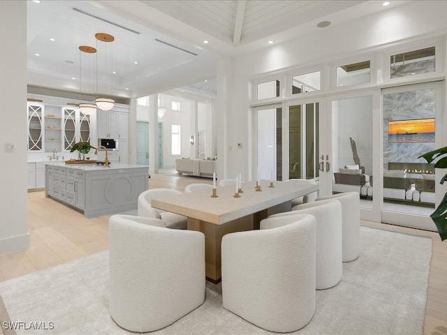 dining area with light wood-type flooring and sink