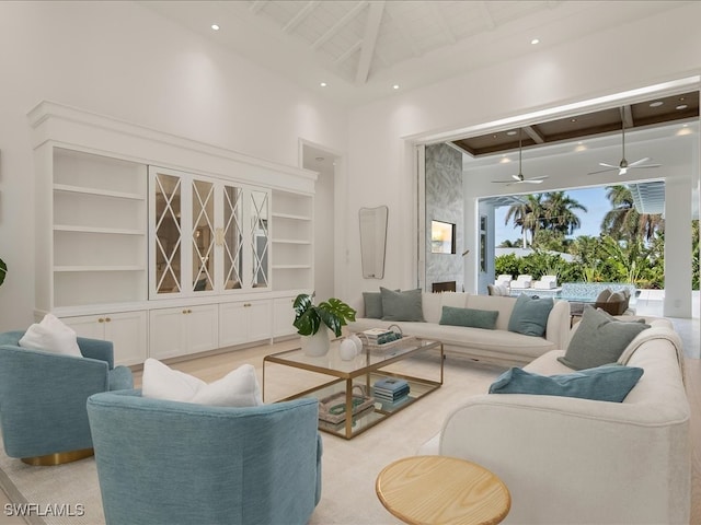 living room with light colored carpet, high vaulted ceiling, and ceiling fan