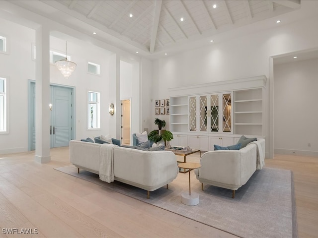 living room featuring light hardwood / wood-style floors, wood ceiling, and high vaulted ceiling