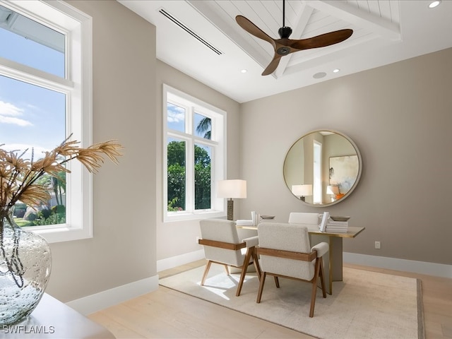 living area featuring lofted ceiling with beams, light hardwood / wood-style floors, plenty of natural light, and ceiling fan