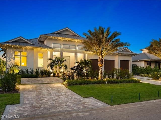 view of front facade with a front yard and a garage