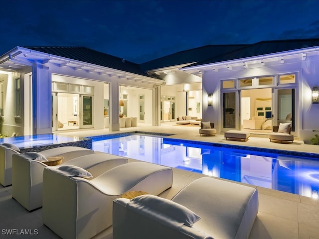 pool at twilight featuring an outdoor hangout area and a patio area