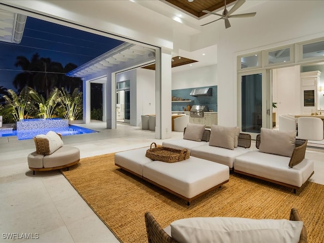 interior space featuring ceiling fan, exterior kitchen, an outdoor living space, grilling area, and a swimming pool