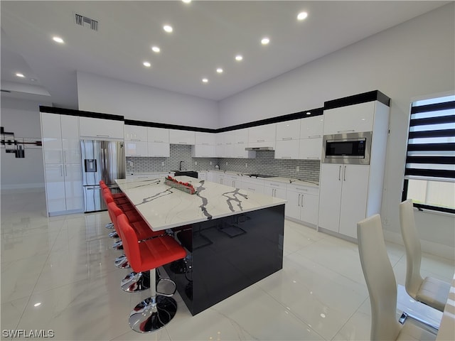 kitchen featuring tasteful backsplash, a kitchen island, and stainless steel appliances