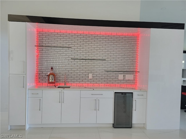 interior space featuring light tile patterned floors, backsplash, and white cabinetry