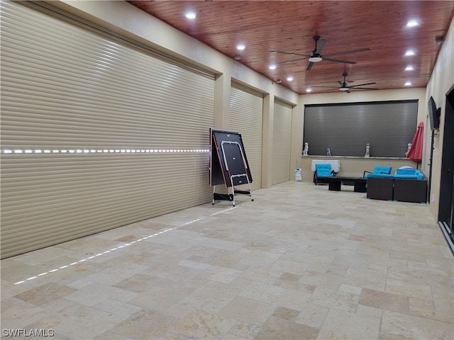 interior space with wood ceiling and ceiling fan