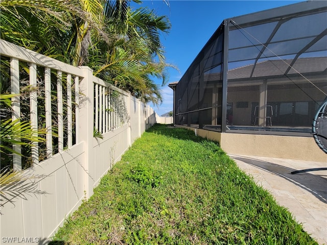 view of yard featuring glass enclosure