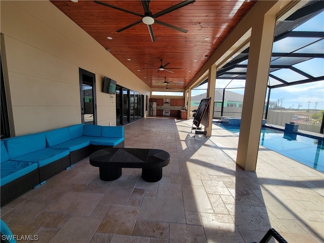 view of patio featuring a lanai, ceiling fan, and outdoor lounge area