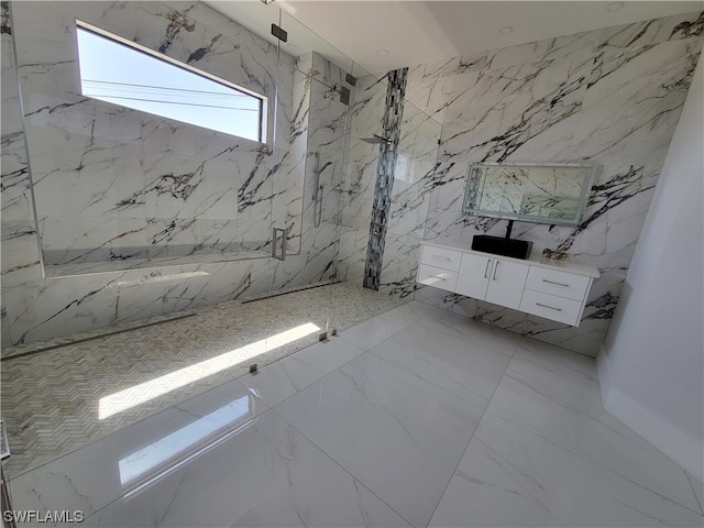 bathroom with vanity and a tile shower