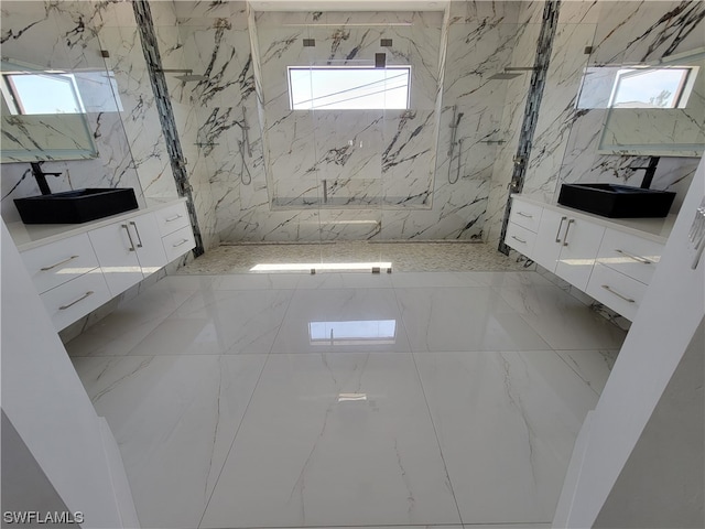 bathroom with a tile shower and vanity