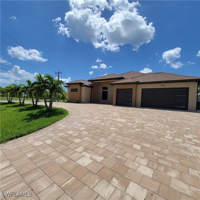 view of front of home with a garage and a front lawn