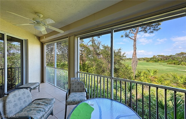 sunroom / solarium featuring ceiling fan