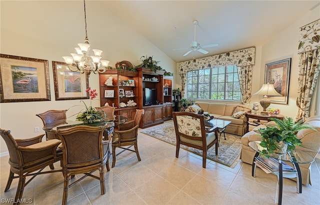 tiled dining room featuring lofted ceiling and ceiling fan with notable chandelier