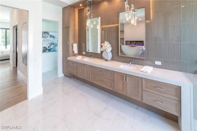 bathroom with tile walls, vanity, and tasteful backsplash