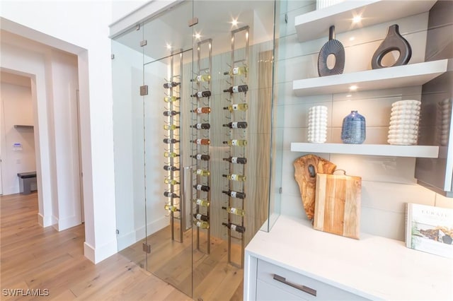 wine cellar with light hardwood / wood-style flooring