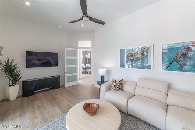 living room featuring ceiling fan and wood-type flooring