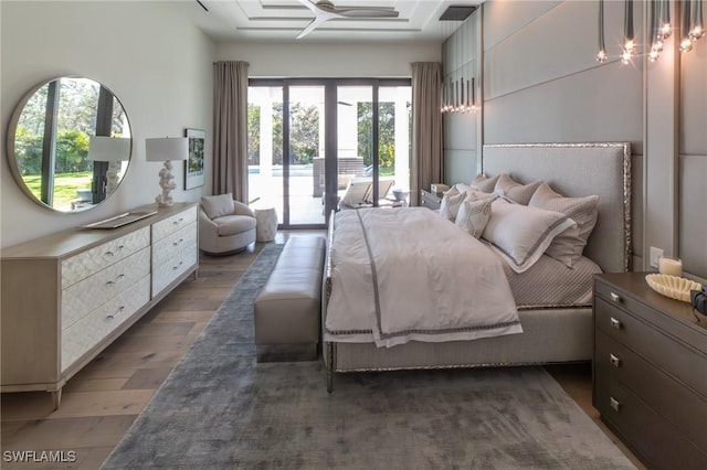 bedroom with access to outside and dark hardwood / wood-style floors
