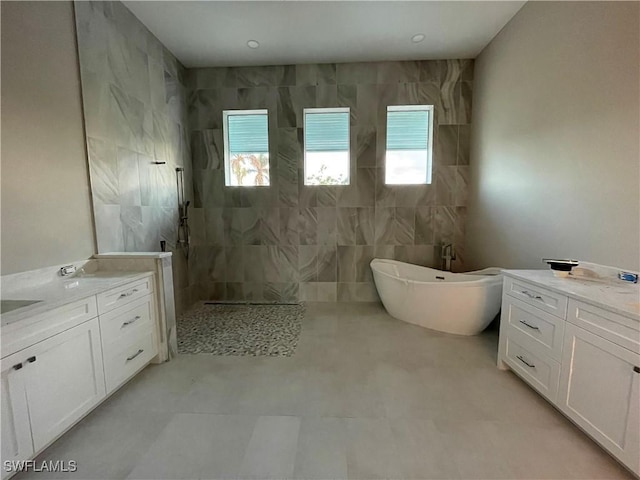 bathroom featuring vanity and separate shower and tub