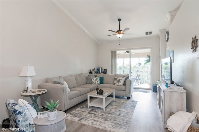 living room featuring crown molding, ceiling fan, and light wood-type flooring