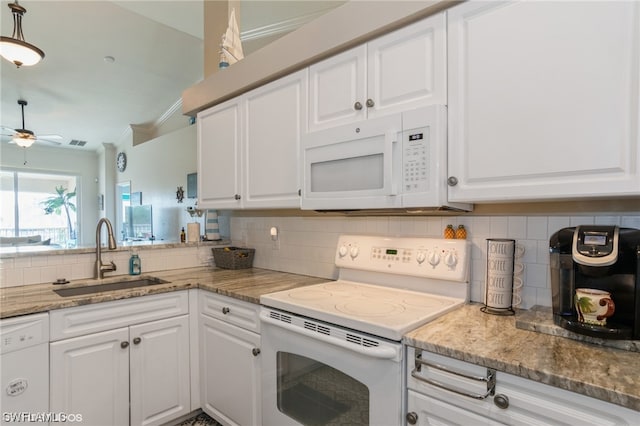 kitchen featuring backsplash, white appliances, ceiling fan, and sink