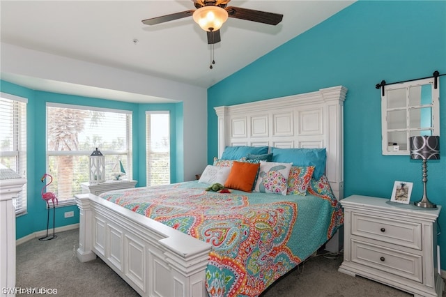 bedroom featuring dark colored carpet, vaulted ceiling, and ceiling fan