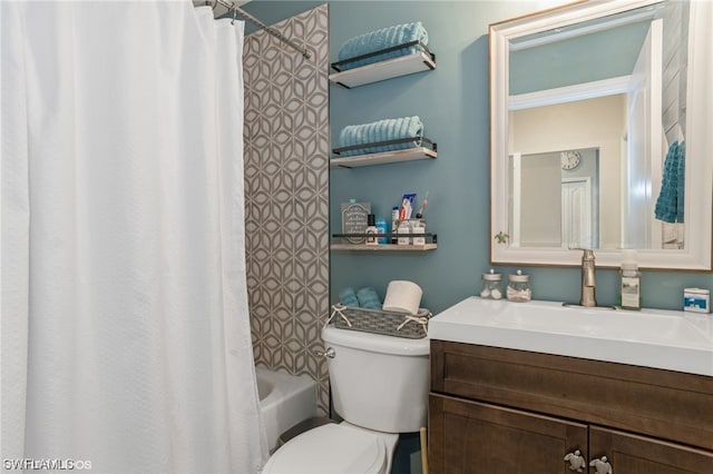 full bathroom featuring shower / bath combo, vanity with extensive cabinet space, and toilet