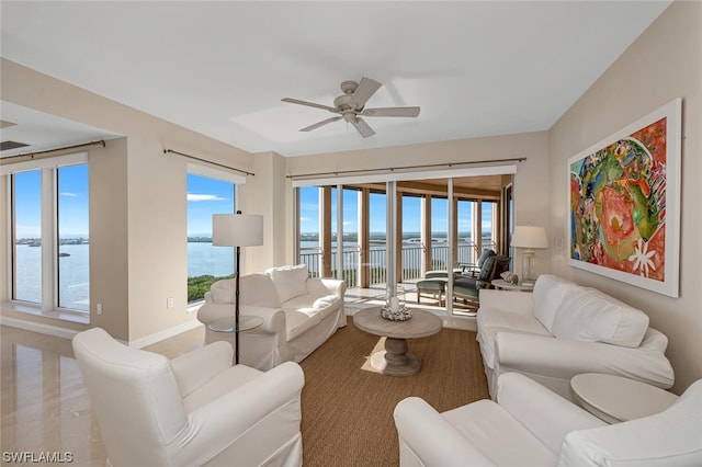 living room featuring a water view and ceiling fan