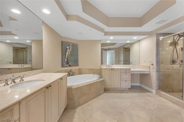 bathroom with vanity and separate shower and tub