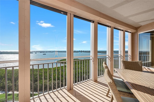 sunroom / solarium with a water view