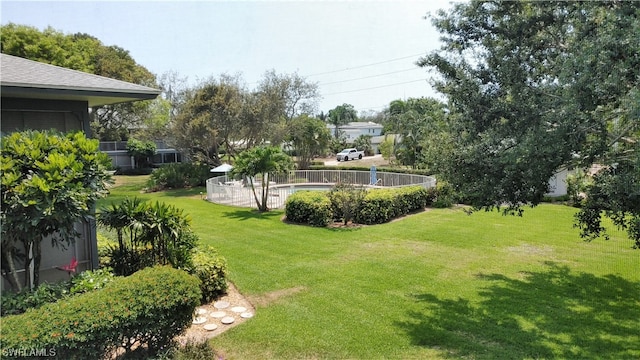 view of yard with a fenced in pool