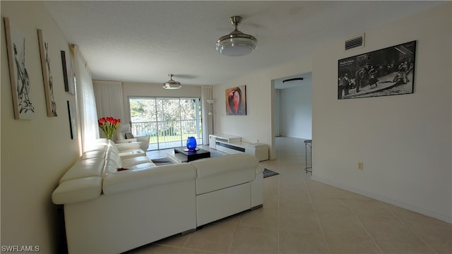 living room with light tile flooring and ceiling fan