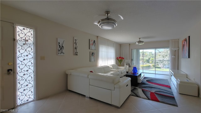 living room with ceiling fan and light tile flooring