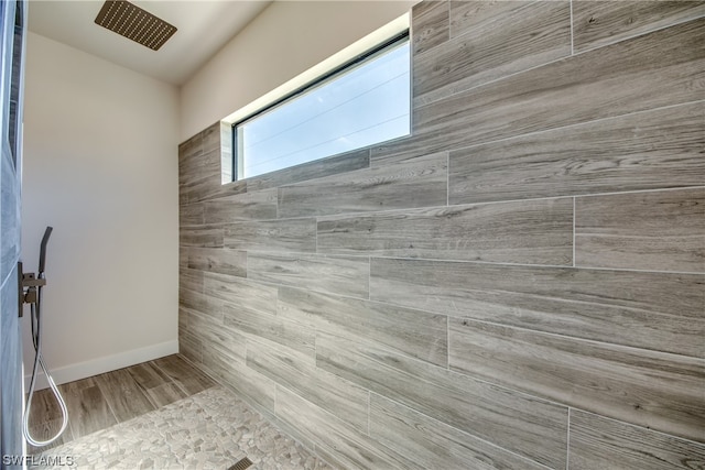 bathroom with tiled shower