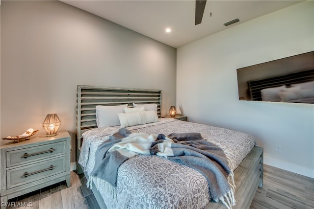 bedroom with light hardwood / wood-style floors and ceiling fan