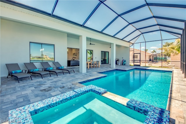 view of pool featuring ceiling fan, an outdoor hangout area, glass enclosure, and a patio