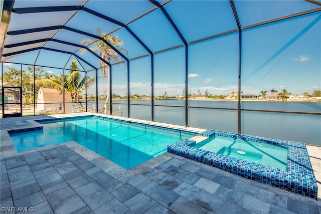 view of pool with an in ground hot tub, glass enclosure, and a patio area