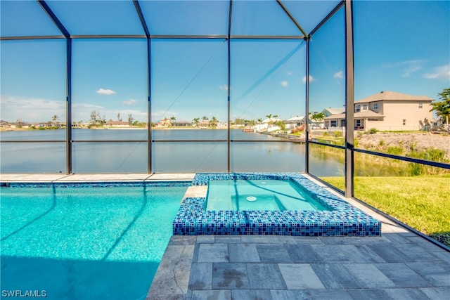 view of pool featuring an in ground hot tub, glass enclosure, and a patio area