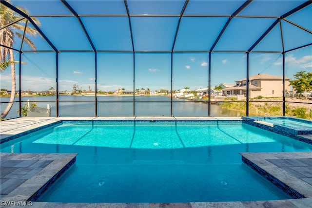 view of swimming pool with an in ground hot tub and a lanai