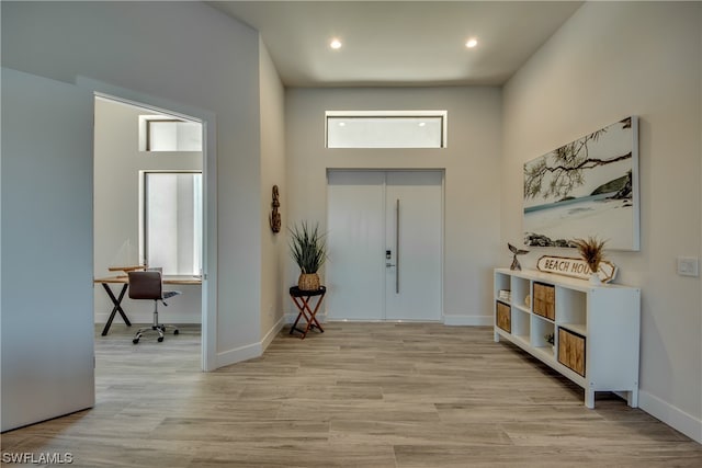 entrance foyer featuring plenty of natural light and light hardwood / wood-style flooring