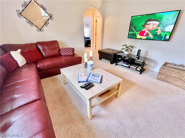 living room featuring light carpet and an inviting chandelier