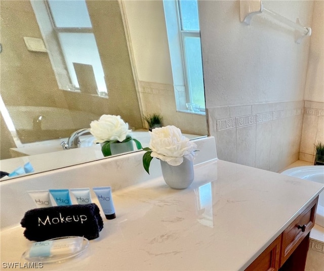 bathroom featuring tile walls and large vanity