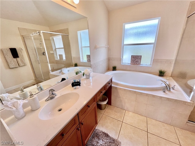 full bathroom featuring toilet, independent shower and bath, large vanity, and tile flooring