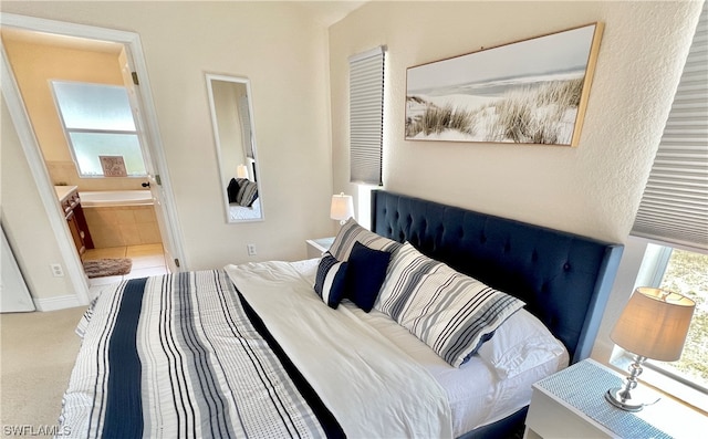 carpeted bedroom featuring connected bathroom