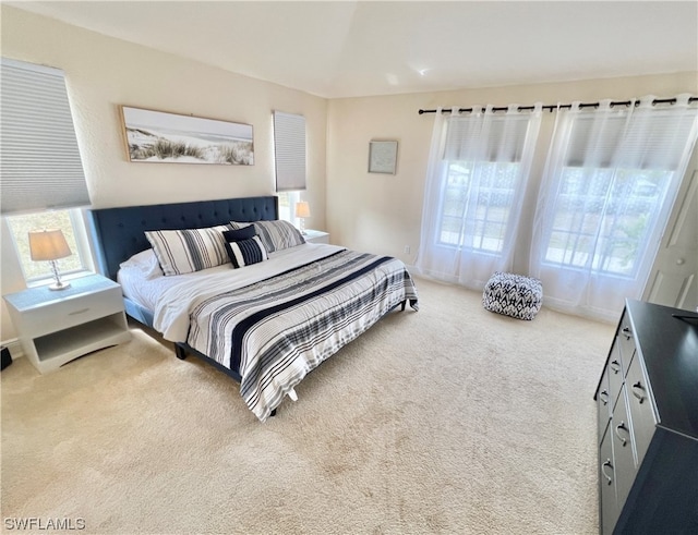 bedroom featuring light carpet