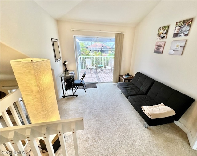 carpeted living room with lofted ceiling