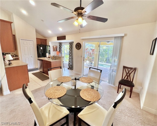 dining space featuring sink, lofted ceiling, ceiling fan, and a wealth of natural light