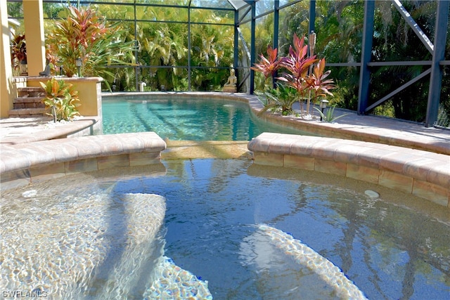 view of swimming pool with glass enclosure