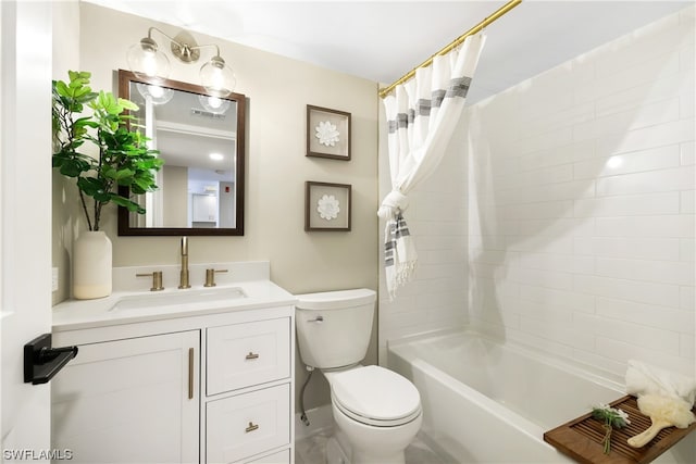 full bathroom featuring vanity, shower / bath combo, and toilet